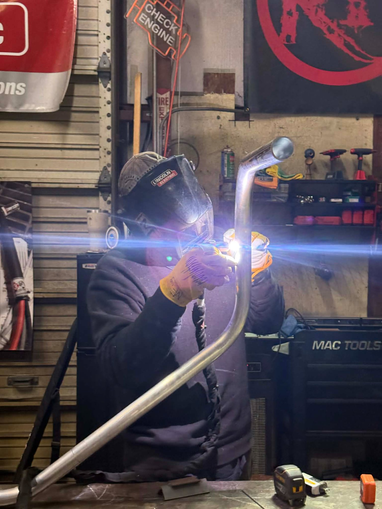 757 Metal Works welding steel pipe in shop — Hampton Roads fabrication