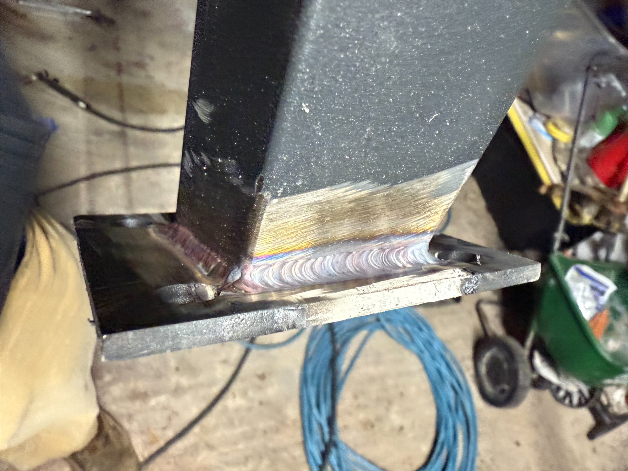 Clean weld bead on steel structural bracket — metal fabrication VA
